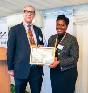 Dr Catherine Mbema receiving the award from Cllr Neil Nerva from Brent Council, one of the judges, at the awards ceremony