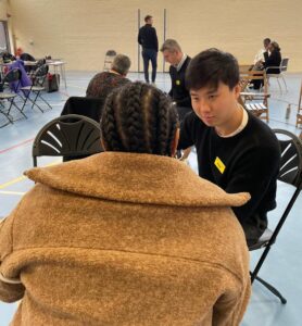 A physiotherapist in consultation with a patient.