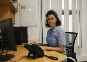 Image of a Lewisham GP sat at a desk