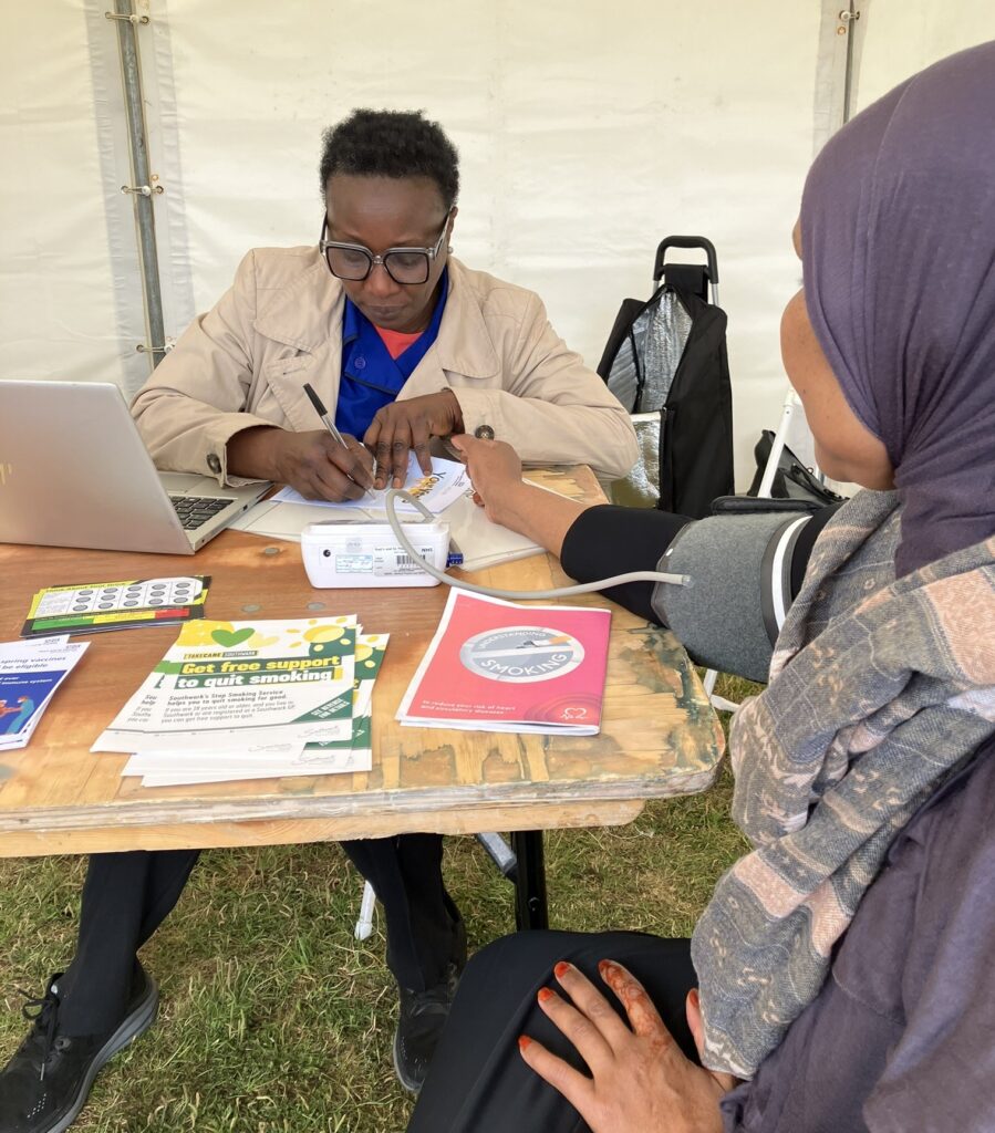Photo of a blood pressure check being performed on a local resident. 