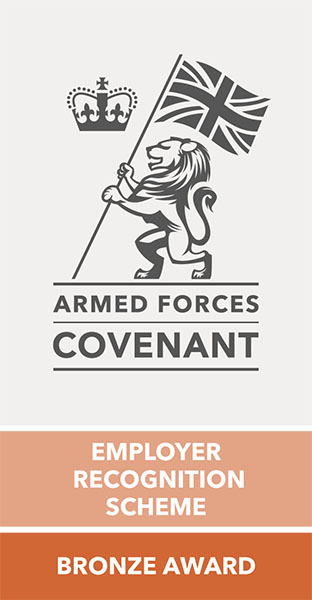 Logo of the Armed Forces Covenant, a lion holding the UK flag, with a crown on the left. Text reads: 'Employer recognition scheme, bronze award'