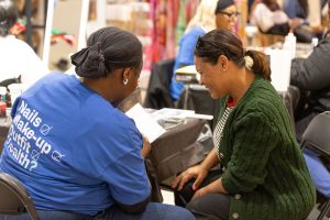 A Glam Squad member delivering make-up consultation to a client