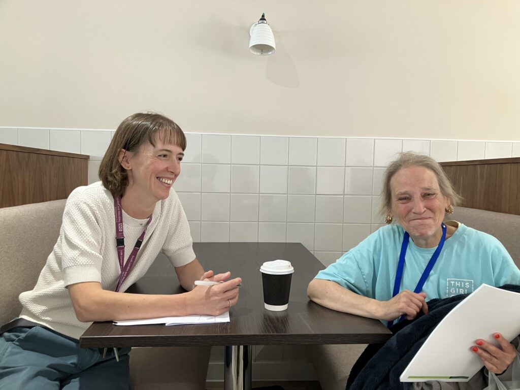 A staff member and visitor at the Southwark Ageing Well event.