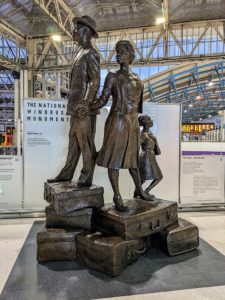National Windrush Monument at Waterloo station, in London. It features a man, a woman and a child on top of some luggage.