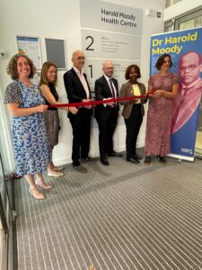 Six people taking part in the ribbon cutting ceremony at Harold Moody Health Centre