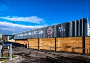 Image of a metal building with lettering that reads 'Bromley Football Club: Est. 1892'.